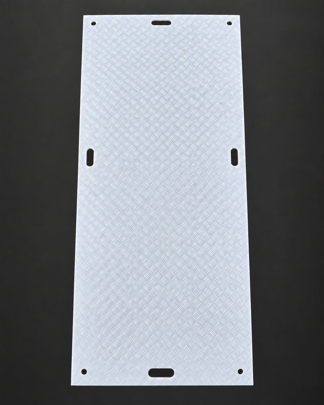 Light-tread side of a white 3 by 8 ground protection mat with four circular corner holes